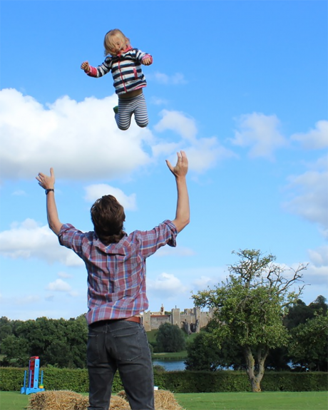 Father throwing child up in the air